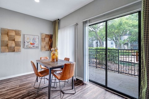 A dining room with a table and chairs.