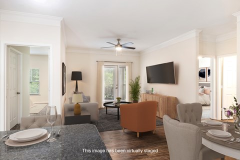 A living room with a dining table set for two.