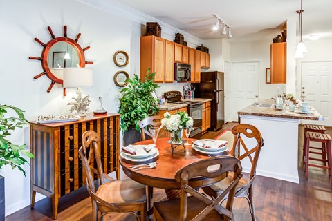 A dining room with a wooden table and chairs.