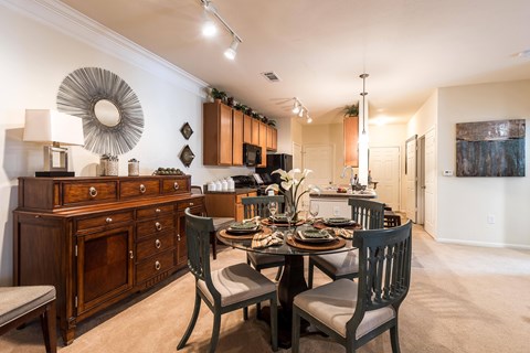 A dining room with a table set for a meal.