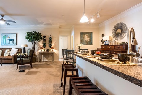 A living room with a dining table set up with bowls and plates.