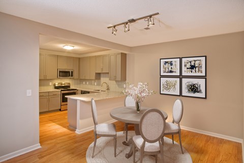 A kitchen with a table and chairs in the middle of the room.