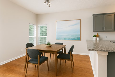 A dining room with a table and chairs.