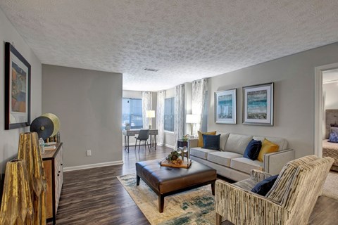 A living room with a couch, coffee table, and pictures on the wall.