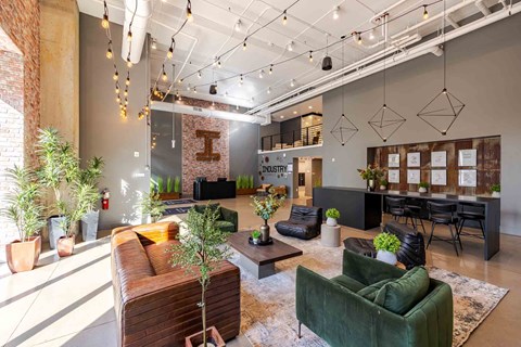 A modern living room with a green couch and a wooden coffee table.
