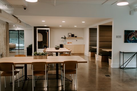 A conference room with a long table and chairs.