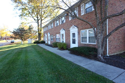 A long brick building with white trim and windows.