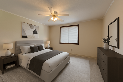 A bedroom with a large bed and a ceiling fan.