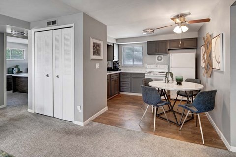 A kitchen with a table and chairs in the middle of the room.