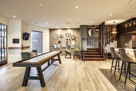 A modern dining room with a long wooden table and chairs.