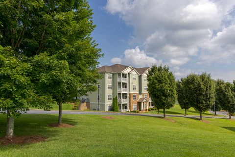 A large grassy area in front of a building.