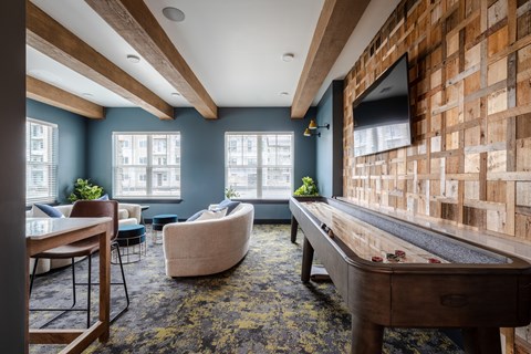 A room with a pool table and a couch.