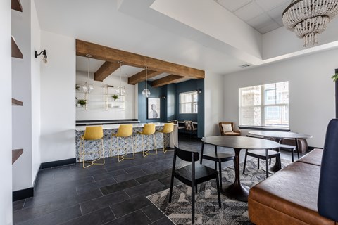 A modern dining room with a wooden table and chairs.