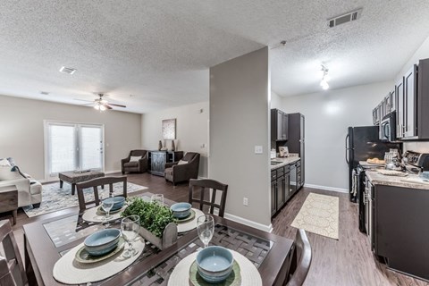 A dining room with a table set for two.