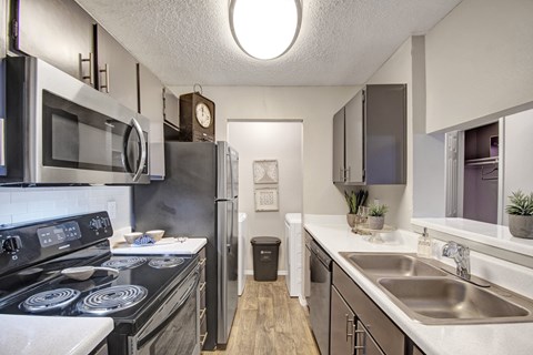 A modern kitchen with a black stove top oven and a black refrigerator.