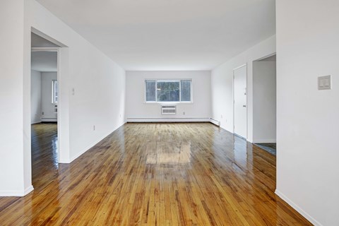 A room with wooden floors and white walls.
