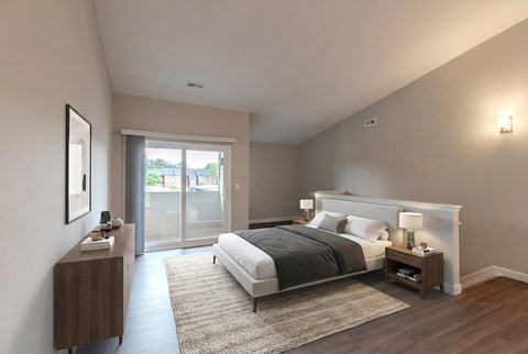 A bedroom with a large bed and a nightstand with a lamp.