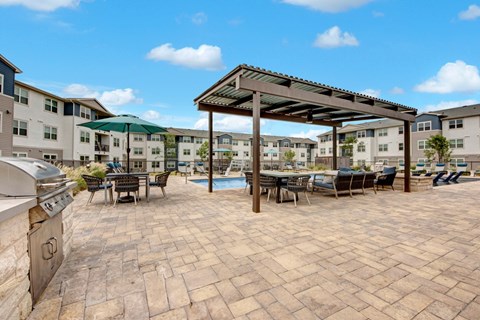 A patio with a table and chairs under a roof.