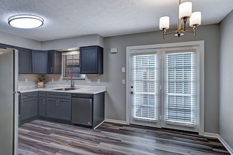 A kitchen with a sink and a refrigerator.