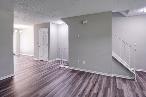 A room with a staircase and a door.