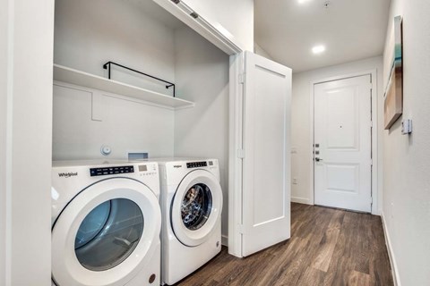 A laundry room with a Whirlpool washing machine and dryer.