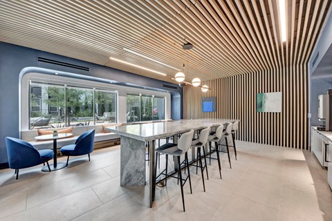 A modern dining area with a long table and chairs.
