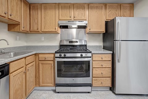A kitchen with a stove, oven, and refrigerator.