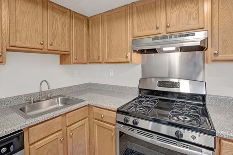A kitchen with a stove and sink.