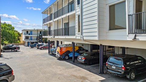 A parking lot with cars and a building in the background.