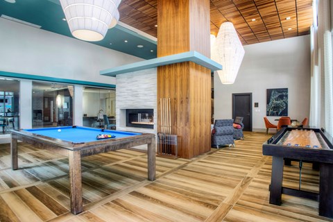 A room with a pool table and a billiard table.