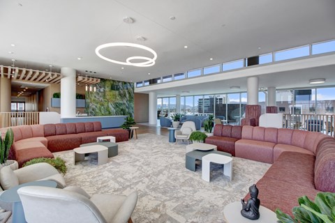 A modern living room with a red sofa and a white chair.