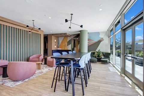A modern dining area with a long table and chairs.