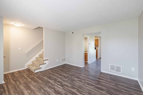 A room with a staircase and a door.