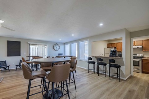 A modern kitchen with a dining table and chairs.