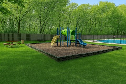 A playground with a slide and a sandbox.