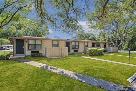 A house with a green lawn in front.