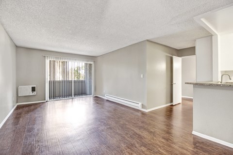 A room with wooden floors and white walls.