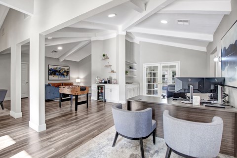 A modern living room with a grey sofa and a wooden floor.