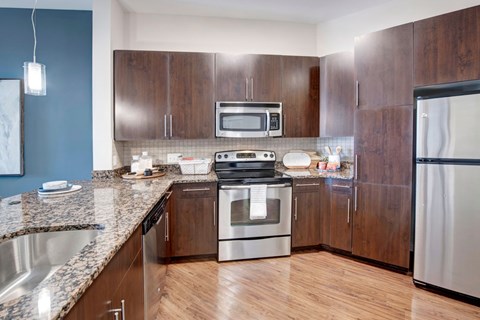 A kitchen with a stove top oven and microwave.