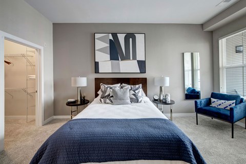 A bedroom with a large bed and a blue couch.