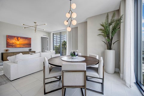 A modern kitchen with a large island and a dining area.