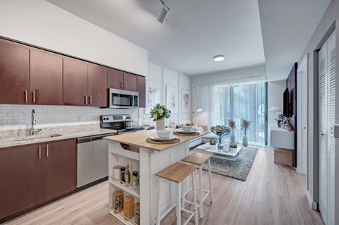 A modern kitchen with brown cabinets and a white island.