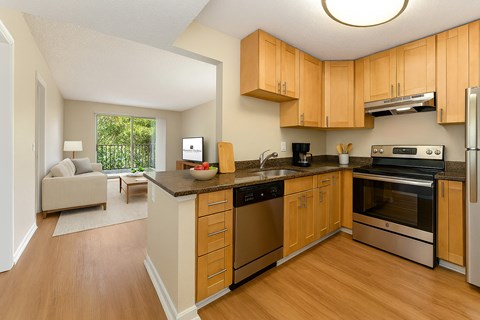 A kitchen with wooden cabinets and stainless steel appliances.