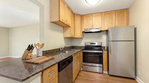 A kitchen with wooden cabinets and stainless steel appliances.