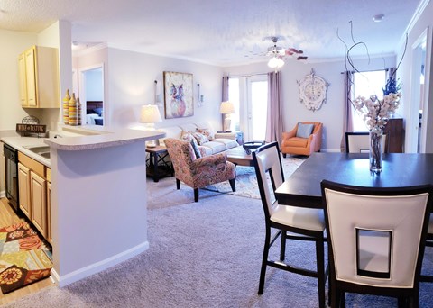 A kitchen with a dining table and chairs.