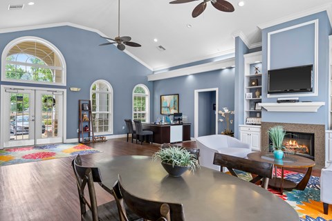 A modern dining room with a large table and chairs.