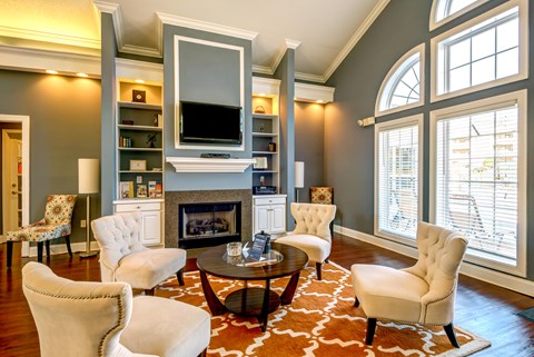 A living room with a fireplace and a television above it.