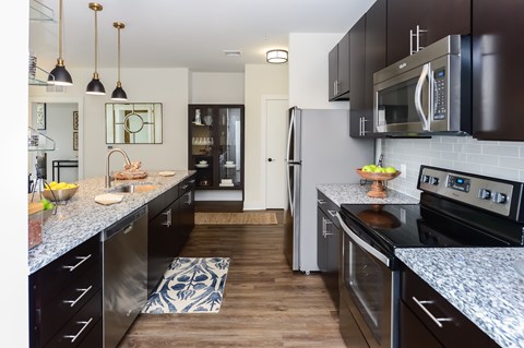 A kitchen with black cabinets and a white counter top.