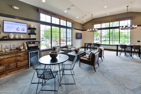 A modern dining room with a large table and chairs.