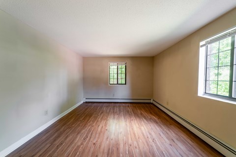 A room with wooden floors and a window.